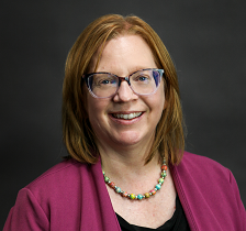 Had shot of Dr. Tracy Labadie wearing a fuchsia sweater and colorful necklace.