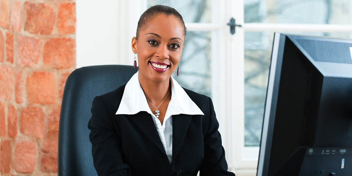 Woman wearing a business suit smiling at camera