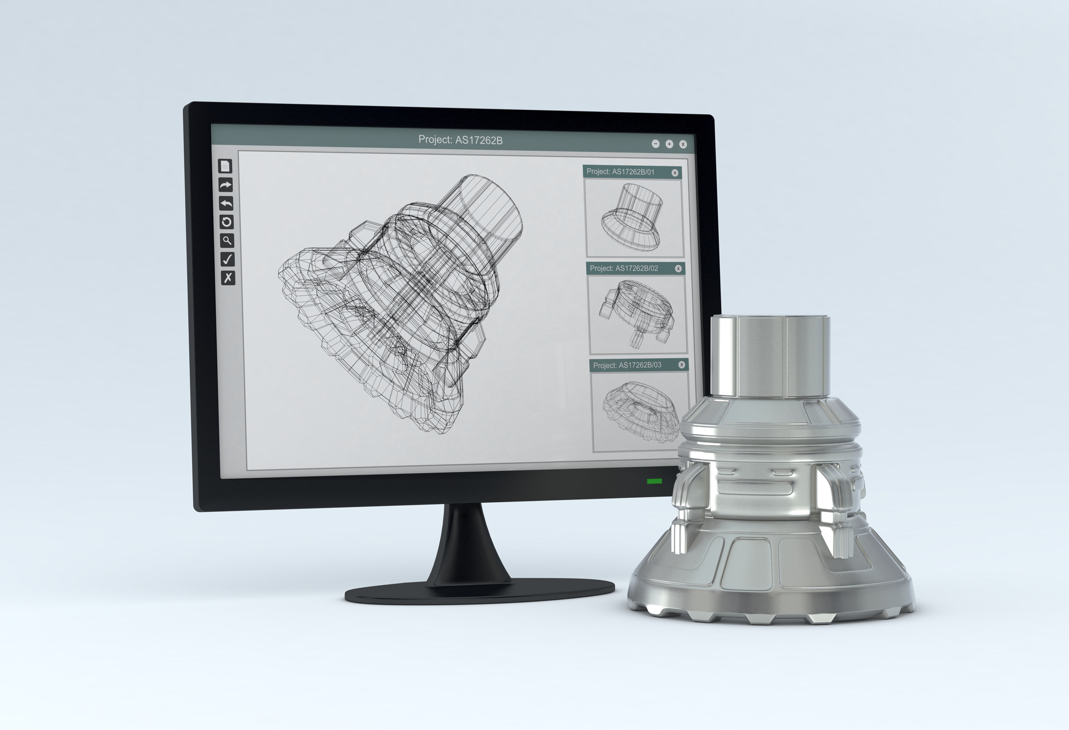 CAD diagram on a computer screen with the actual product, finished product, sitting in front of the computer screen