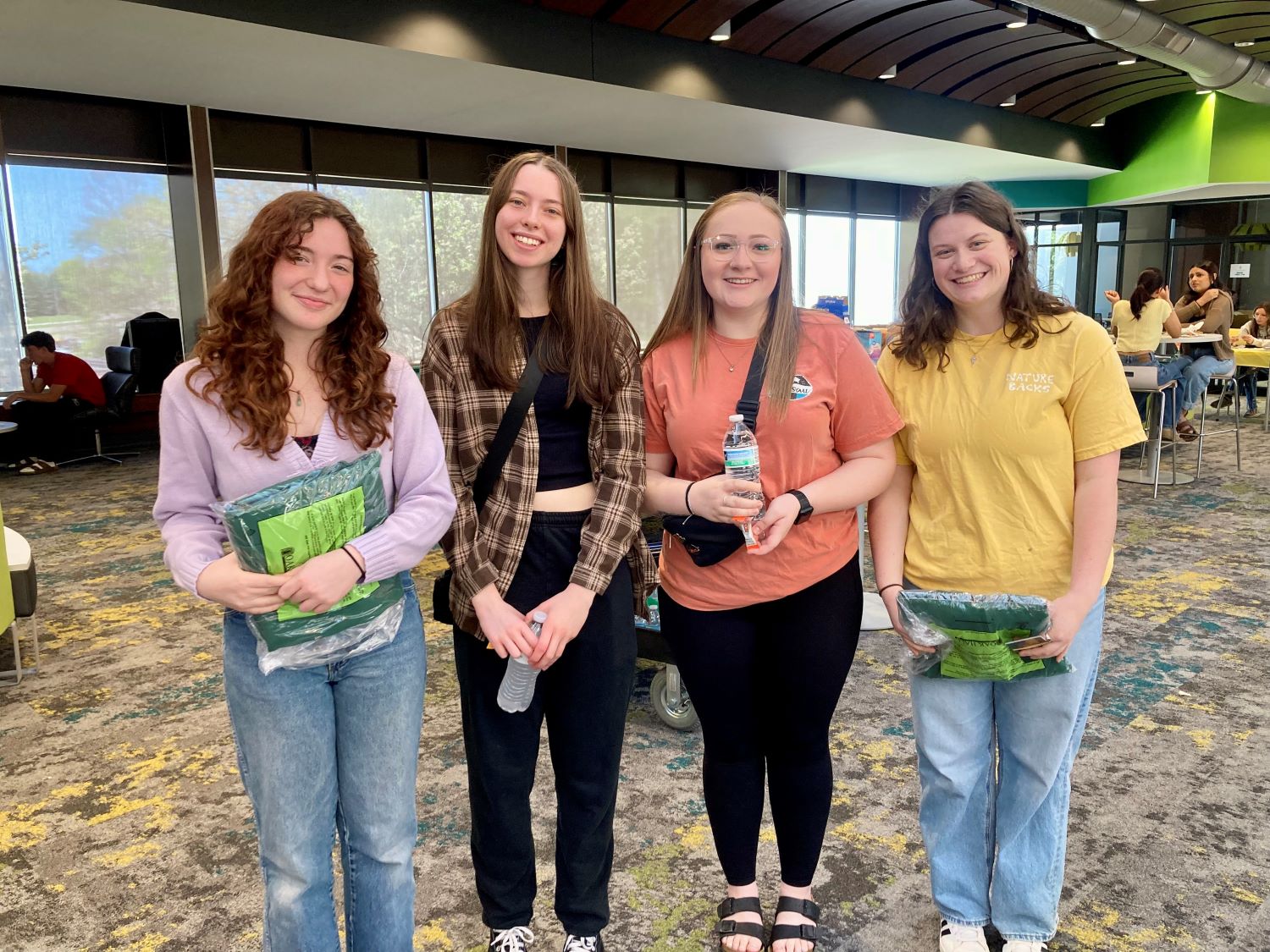 Group of female students standing side-by-side on Glen Oaks campus